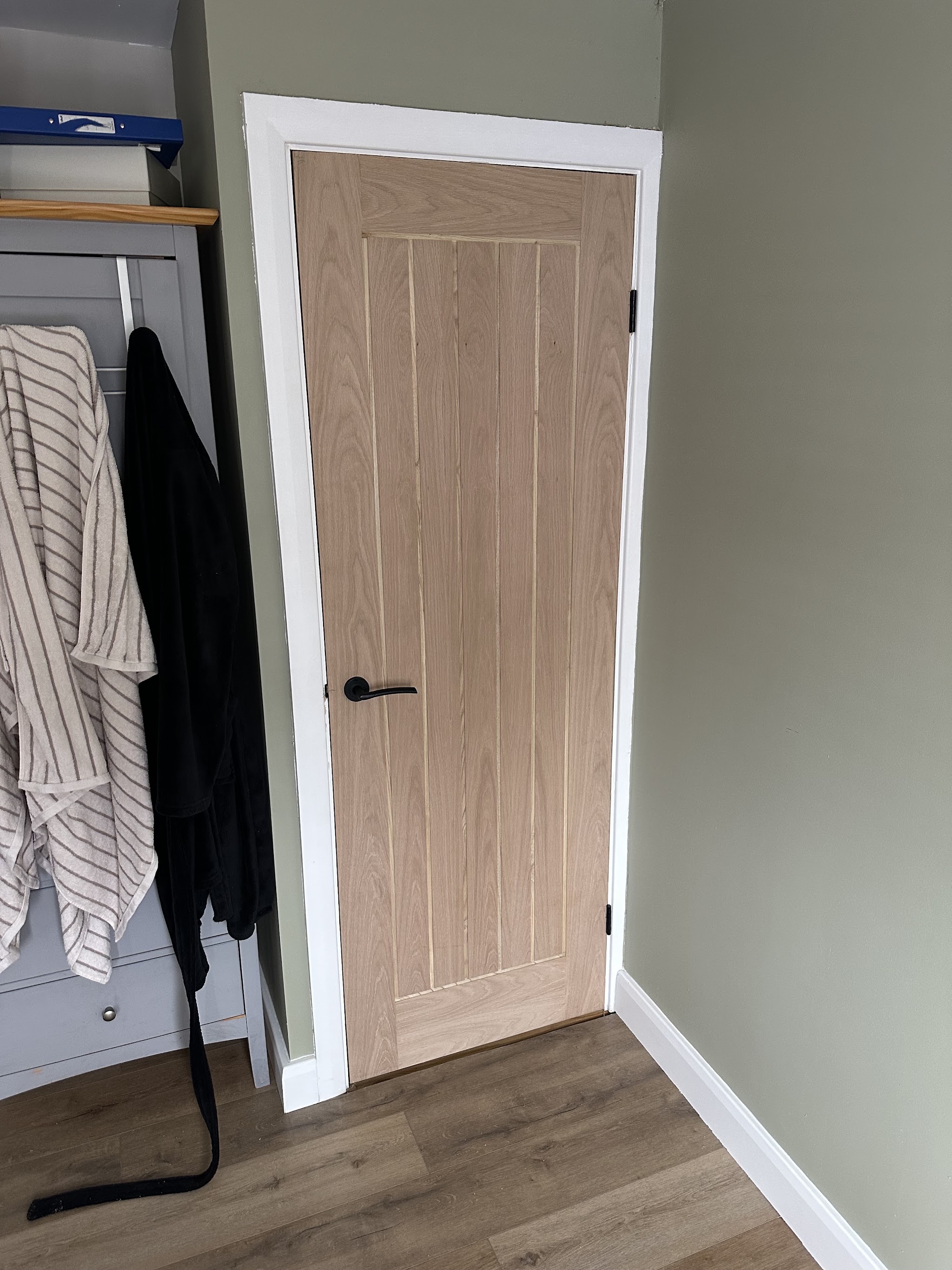 Oak internal door with a black handle, freshly fitted