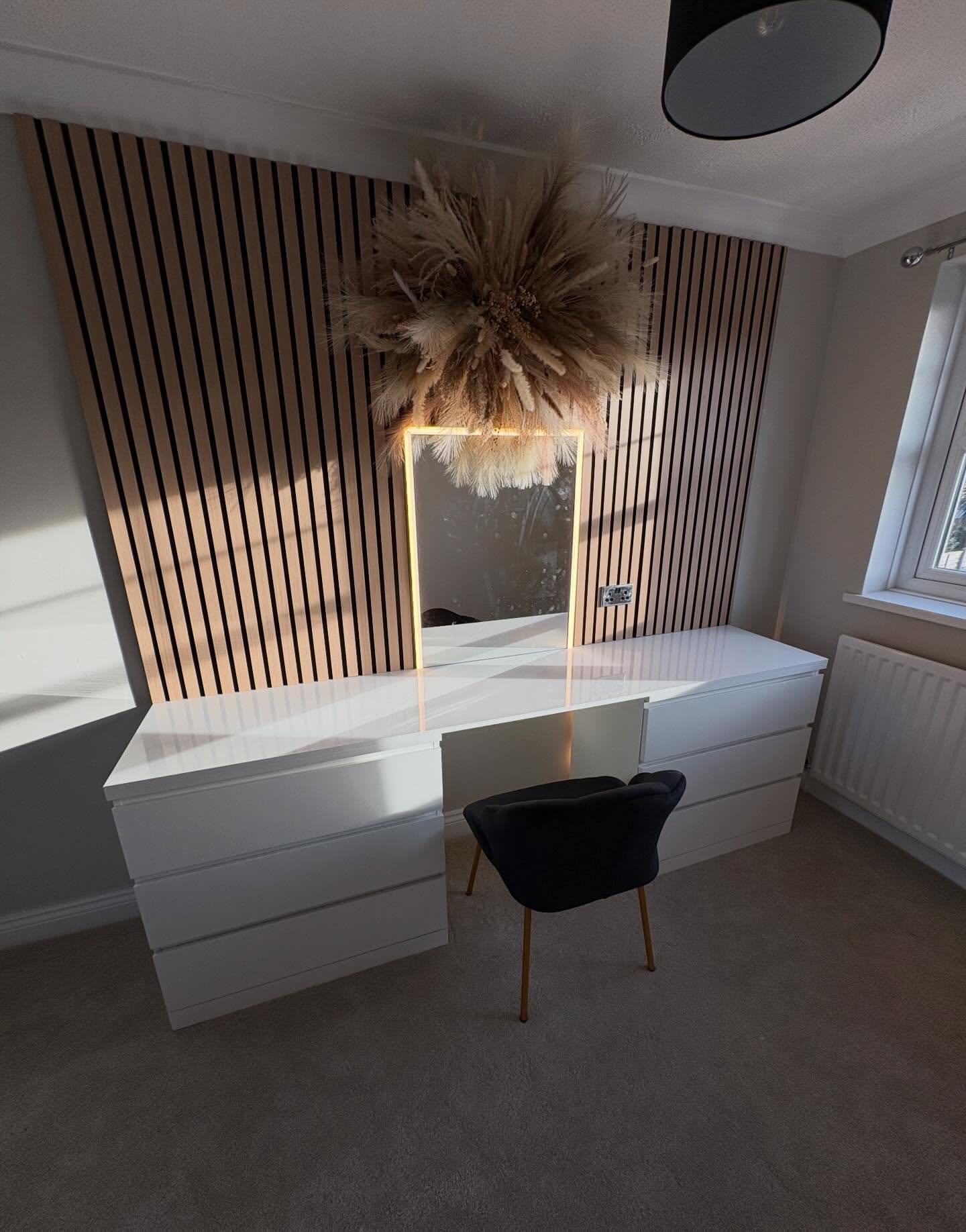 Slatted timber feature wall with a built-in dressing table and lit mirror